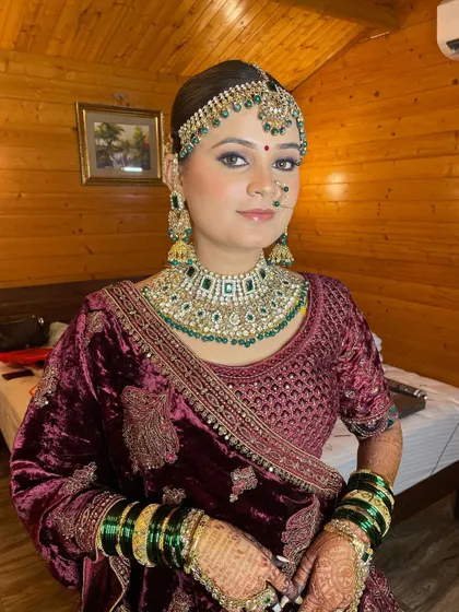 Showcasing the royal elegance of this bride's reception look, with soft glam makeup that complements her rich velvet lehenga.