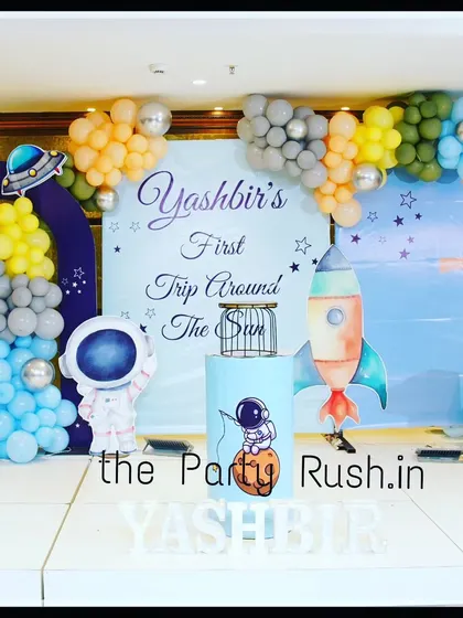 A cropped version of Yashbir's "First Trip Around the Sun" party, focusing on the charming space-themed backdrop and props.