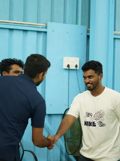 A moment of connection as our Head Coach interacts with other coaches and staff, fostering a collaborative and positive training environment.