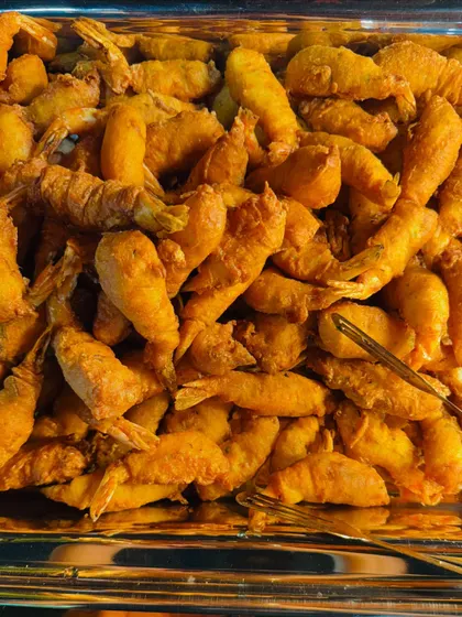 A tray full of perfectly golden fried prawns, a simple yet irresistible offering.