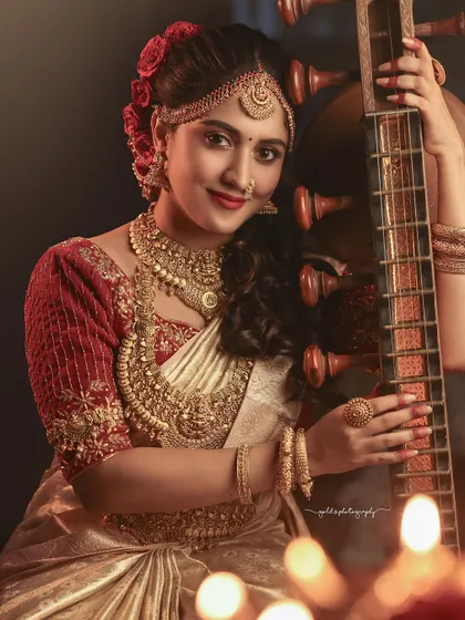 A festive Deepavali-themed shoot with an actress and a veena. The warm, candle-lit setting and rich traditional attire create a celebratory and artistic atmosphere.