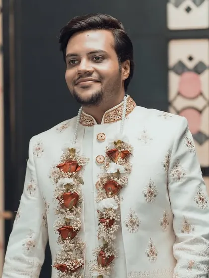 A handsome portrait of the groom in his elegant white sherwani, captured as he arrives for the ceremony.