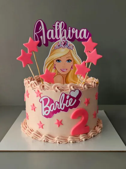A sweet and simple Barbie cake for Aathira's 2nd birthday. This cake features a Barbie theme with pink stars and piping, perfect for a little fan.