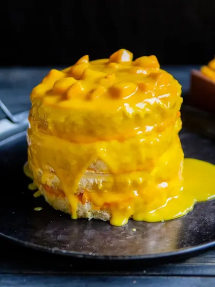 A shot of our Mango Pull Me Up cake after the sauce has cascaded down, pooling beautifully at the bottom. It's a dessert and an experience in one.