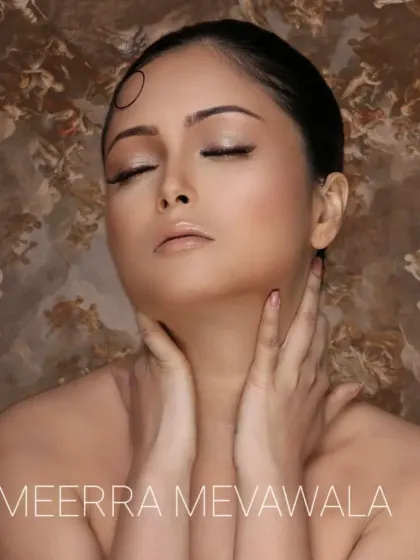 An eyes-closed shot to highlight the soft, neutral eyeshadow work on a medium complexion.