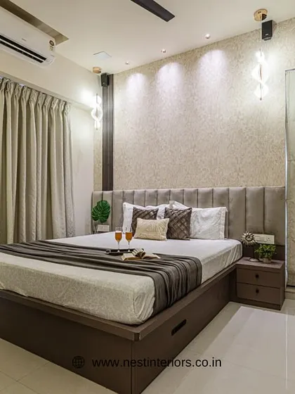 This master bedroom design focuses on earthy tones and textures for a warm, inviting feel. The under-bed storage drawers are a practical addition for keeping the space tidy.