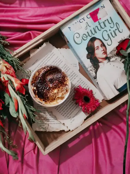 A top-down flatlay of the coffee and book scene. This perspective showcases all the different elements of the composition, telling a story of a relaxing afternoon.
