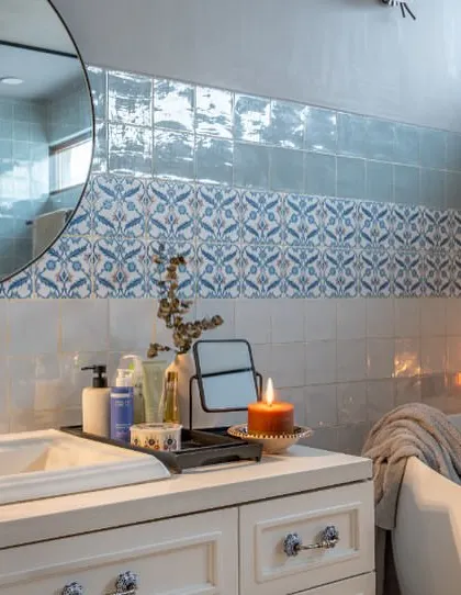 A close-up of the vanity in the Dhaka bathroom. The mix of modern fixtures, patterned tiles, and soft, ambient lighting creates a space that is both functional and atmospheric.