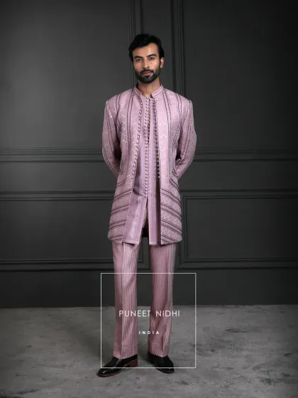 An ensemble that whispers royalty. Dusty salmon silk with a gentle sheen, woven stripes for depth, and fabric-covered loop buttons that carry the artistry of our timeless heritage.