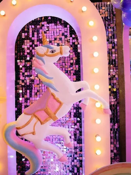 More details from the unicorn stage, including a large carousel unicorn, rainbow props, and pastel balloon arrangements. I love creating these immersive, picture perfect settings.