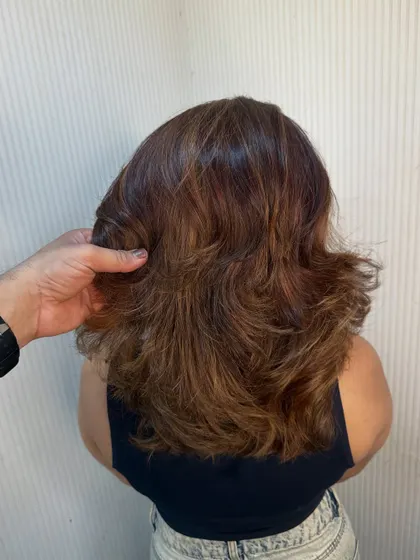 Our stylist showing the bounce and volume in this freshly cut and styled hair.