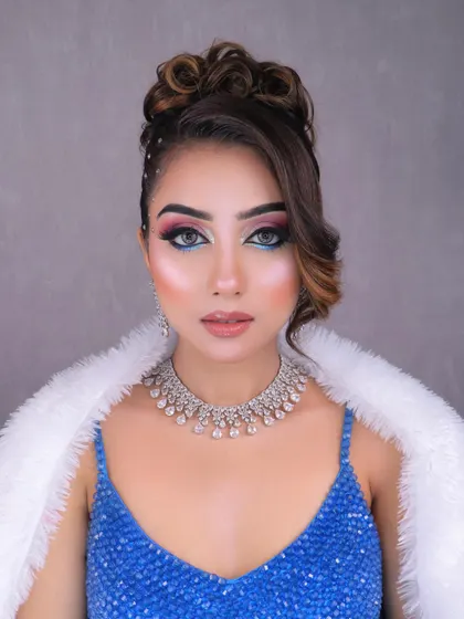 A direct, powerful gaze showcasing the unique and colorful eye makeup that makes this look a showstopper.