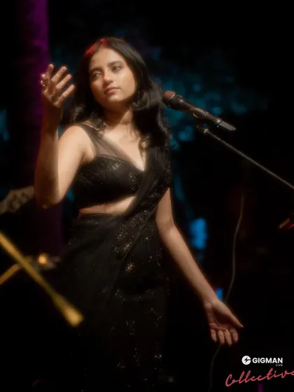 A dramatic shot from a performance. The stage lighting and atmosphere add so much to the musical experience.