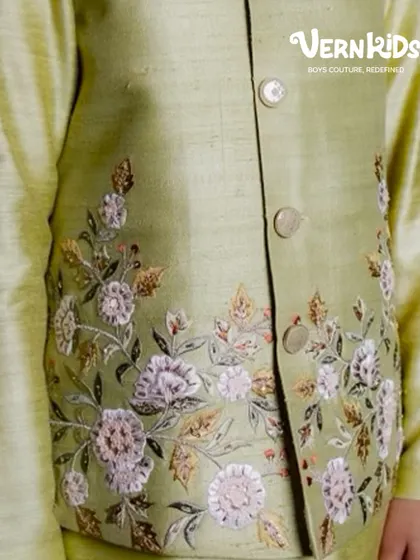 A detailed shot of the hand embroidery on our sage green Bundi set. The delicate floral pattern showcases the love and craftsmanship stitched into every piece.