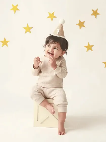 Looking up with pure wonder. This little boy, surrounded by stars, is the center of his own universe on his first birthday.