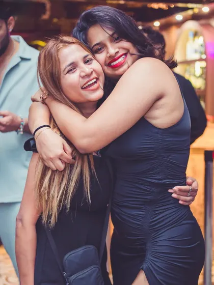 Friends embracing and smiling for the camera.