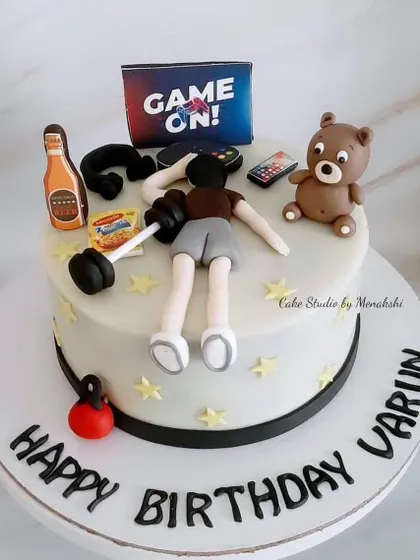 For Varun, with all the things he loves. This cake is a fun mix of gaming, gym, beer, and his teddy bear, a truly personalized birthday surprise.