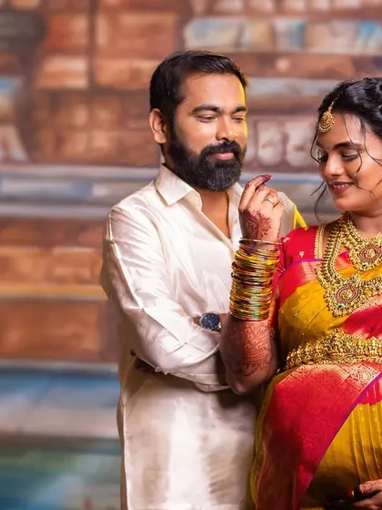 A candid interaction between the couple during their traditional photoshoot. These unposed moments often become the most treasured photographs, reflecting the real emotions of the day.