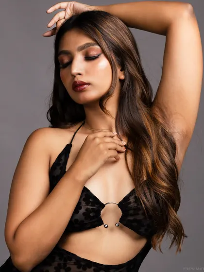 An emotive pose with the model's eyes closed, creating a soft and sensual mood.