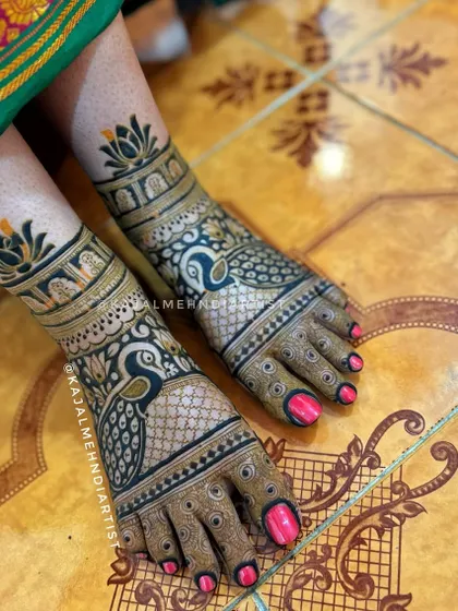 A bold and beautiful peacock design for the bride's feet, complemented by lotus motifs on the ankles.