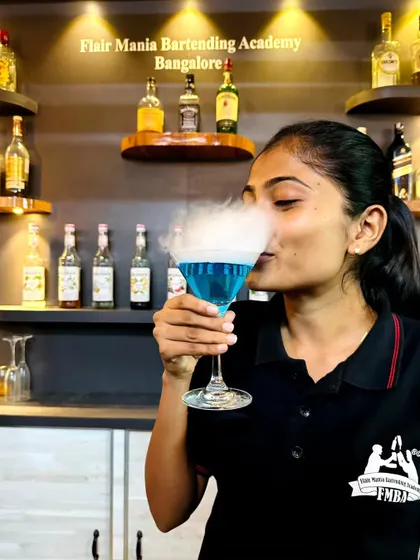 A guest enjoying a smoking blue cocktail at our Bangalore academy. We can bring this same sense of wonder to your event.