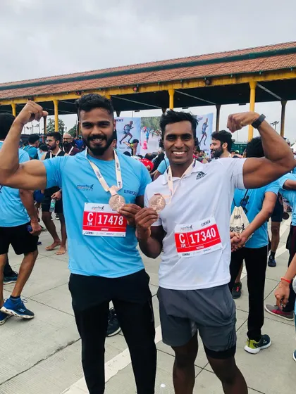 We run to win. Posing with a fellow runner after a marathon event. The community and shared sense of accomplishment are a huge part of what makes fitness a lifestyle.