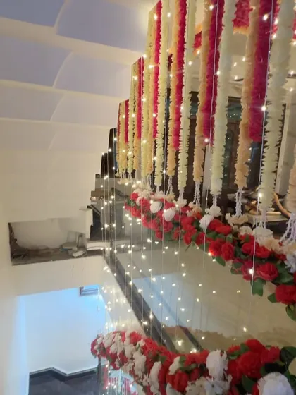 The staircase of a wedding house decorated with hanging floral strings and fairy lights. This shows how I carry the festive decor throughout the home.