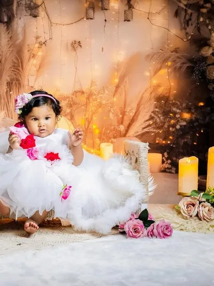 A portrait from Sarveksha's dreamy, candle-lit photoshoot. The soft textures of the set and her beautiful white dress come together to create an angelic and serene photograph for her pre-birthday collection.
