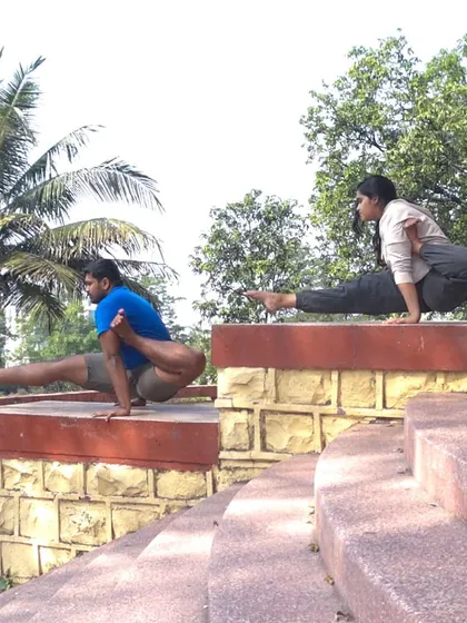 Partner yoga is a fun way to build strength and trust. Here, we're practicing a lifted staff pose (Yogidandasana), which requires serious arm and core strength from both partners.