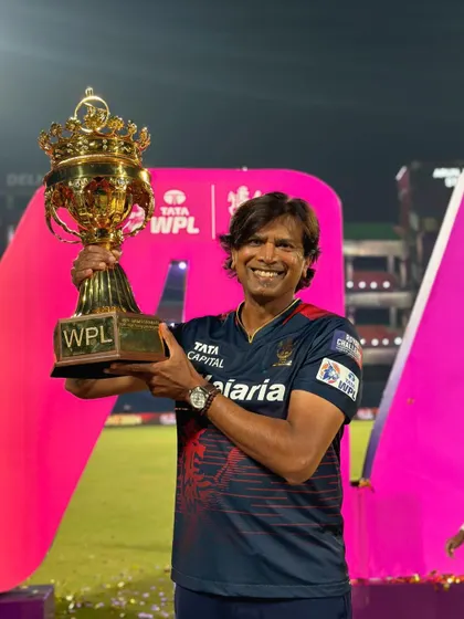 A duplicate of image 83, holding the WPL trophy high.