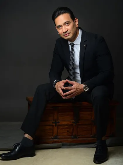 A full-length seated portrait using a prop. This type of shot is great for adding variety to a corporate portfolio and can be used in feature articles or website banners.