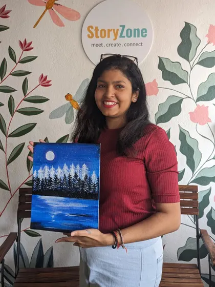 A participant with her beautiful painting of a moonlit lake scene. The reflection on the water is captured perfectly.