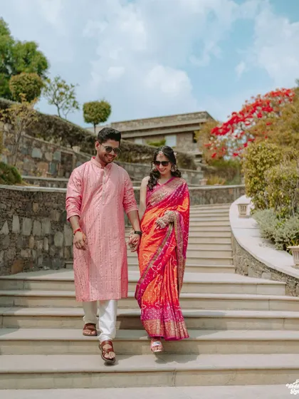 The couple makes a grand entrance down the stairs at the Ramada resort in Udaipur for their Haldi ceremony.