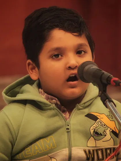 One of our "little champs" singing with all his heart at the 'Swarveni Aradhana'. It is beautiful to see devotion blossom at such a young age.
