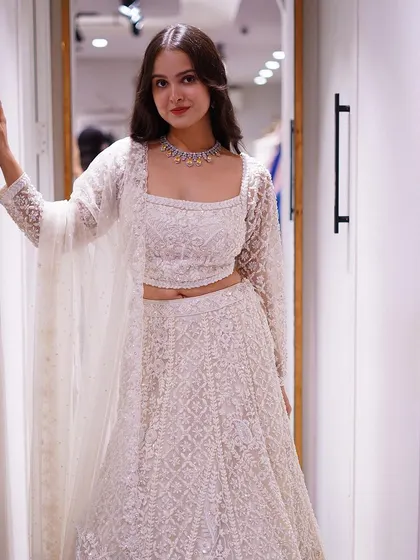 A timeless classic with a modern twist. This white chikankari-style lehenga with a jacket is the epitome of grace and sophistication.