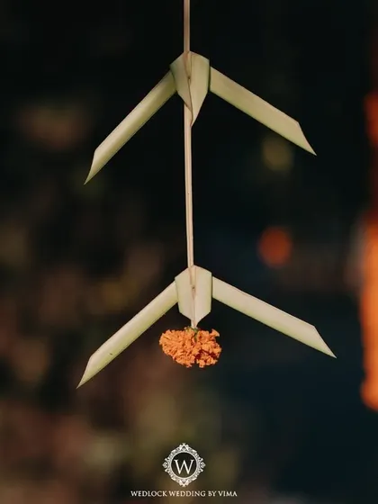 Hand-folded coconut leaves used as hanging decor for a Haldi ceremony. This sustainable and traditional craft adds a unique and rustic charm to the event.