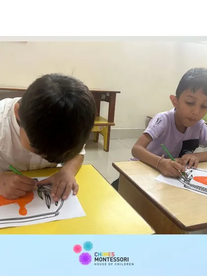 Two boys work side-by-side on their art projects, concentrating on their coloring and drawing.