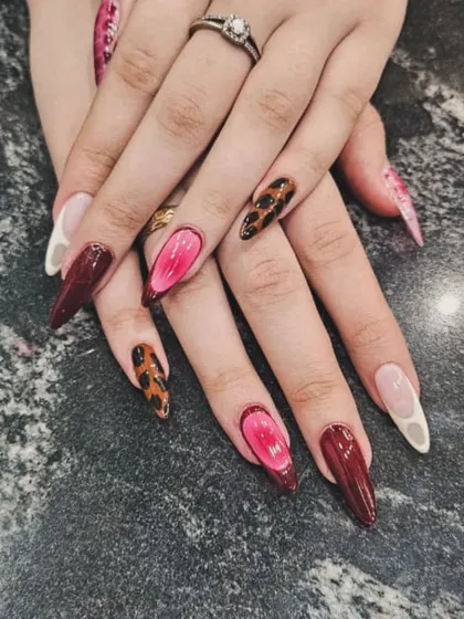 For a look that's both fierce and feminine, we mixed different styles in this set. It features bold leopard print, a vibrant pink 3D jelly nail, and deep burgundy on long, stiletto-shaped extensions.