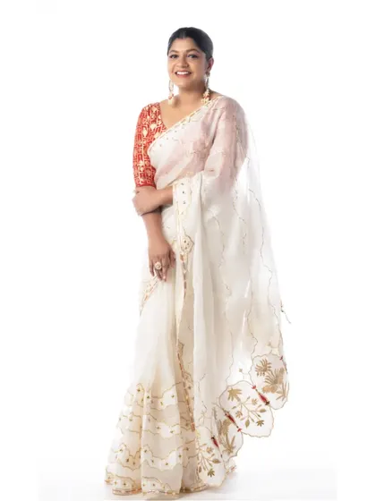The final look for Aparna Balamurali. The white organza saree is draped to create a look of ethereal elegance.