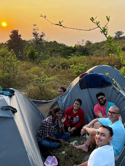 Campers relaxing in their tents as the sun sets over the hills. Our camping experiences allow you to fully immerse yourself in the tranquility of nature.