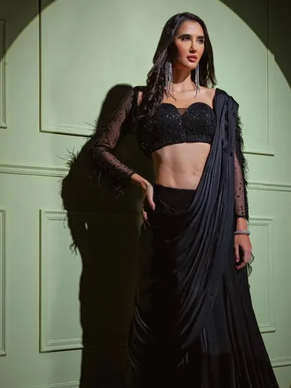 A full shot of the black feather-sleeve drape saree, a perfect blend of classic elegance and modern couture.