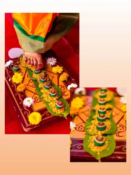 A detail shot of the Saptapadi ritual, where the bride touches a series of betel nuts with her foot, symbolizing the seven steps of their journey together.
