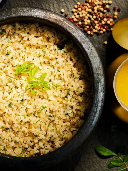 A comforting meal of broken rice with a side of golden ghee. This simple, sattvic dish is designed to soothe the gut, balance the doshas, and support the body's natural recovery process.