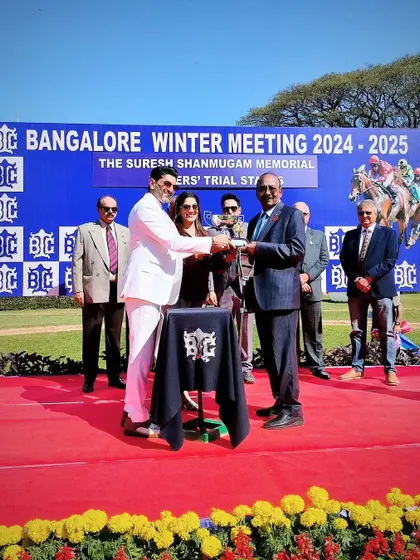 Mr. Sanjiv Shanmugam presents the memorial trophy to the winning connections.