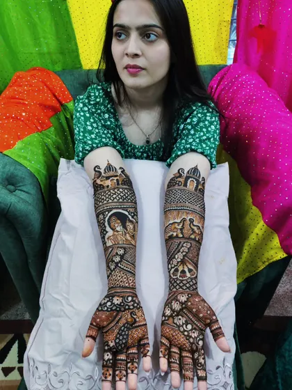 A beautiful bride posing with her full-arm story mehandi, ready for her wedding celebrations.