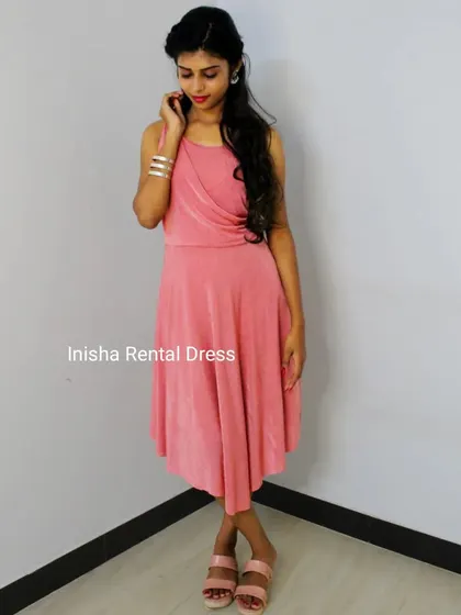 A full view of our pink mini-frock with a stylish wrap-style bodice. This is a great choice for a simple and elegant look.