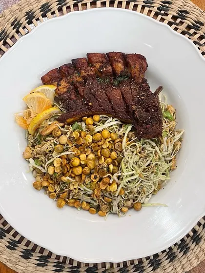 A perfect pairing of textures and flavors. Here, our succulent pork ribs are served over a bed of Singju salad, a traditional Manipuri salad made with shredded cabbage, roasted chickpeas, and perilla seeds.