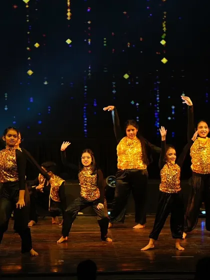 The entire kids' hip hop group striking a pose together. Their coordinated outfits and confident stances show their team spirit.
