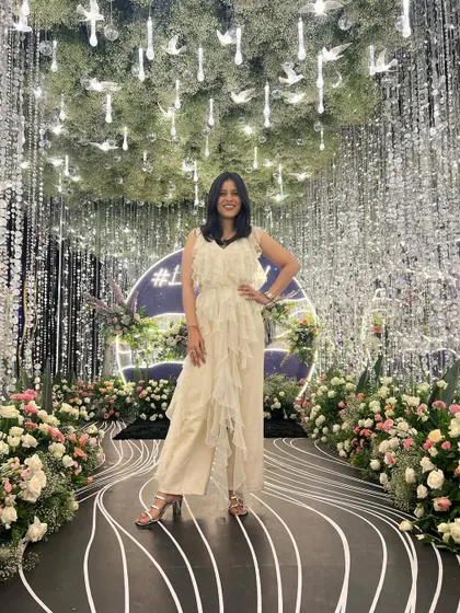 Posing against a stunning, shimmery backdrop that matched the vibe of my outfit. This white ruffled jumpsuit was an absolute showstopper for the sangeet.