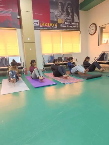 Our athletes participating in a cool down and yoga session at the end of the week, focusing on core exercises.